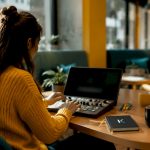Futuristic video editing workspace with console and screens