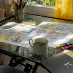 Old-style storyboard sketches on wooden table