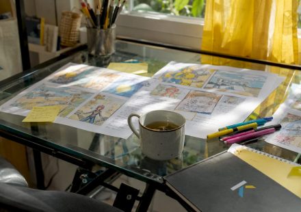 Old-style storyboard sketches on wooden table