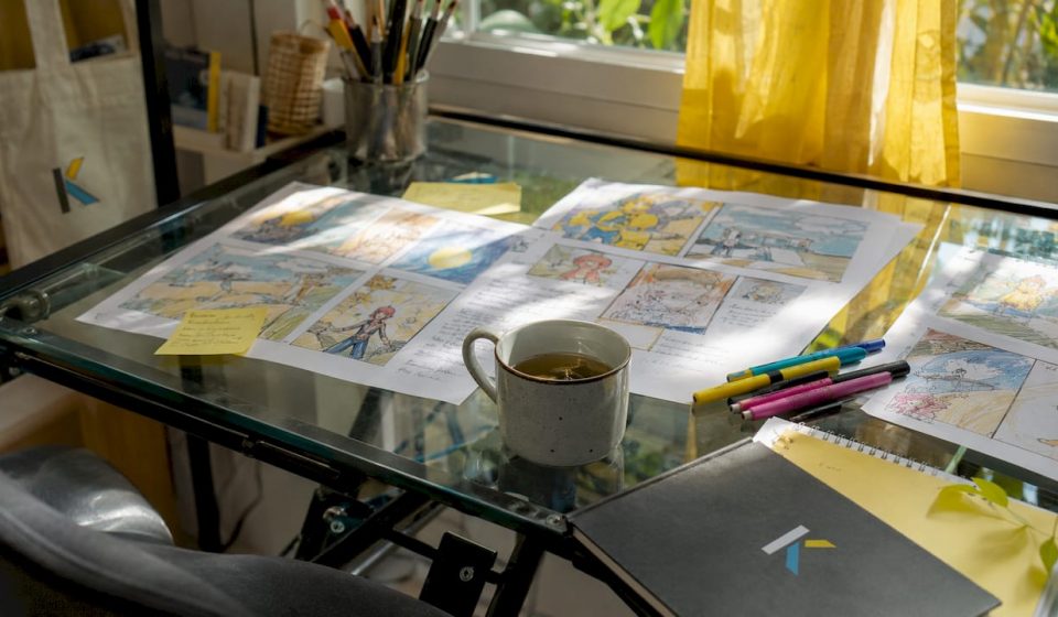 Old-style storyboard sketches on wooden table