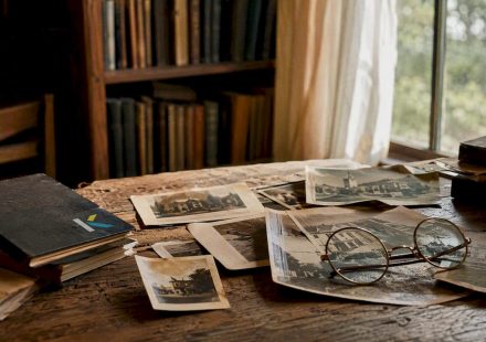 Vintage photos scattered on wooden desk