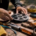 Hands splicing vintage film reel