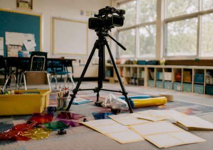 Vintage classroom video camera on wooden tripod