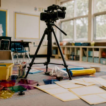 Vintage classroom video camera on wooden tripod
