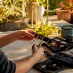 Hands cutting vintage film strip on wooden table