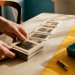 Hands arranging vintage photographic frame prints