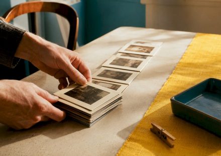Hands arranging vintage photographic frame prints