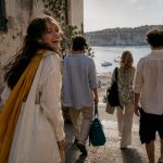 Friends exploring a sunlit coastal town
