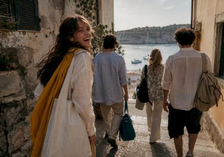Friends exploring a sunlit coastal town