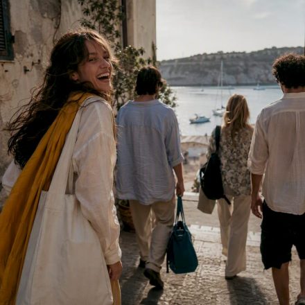 Friends exploring a sunlit coastal town