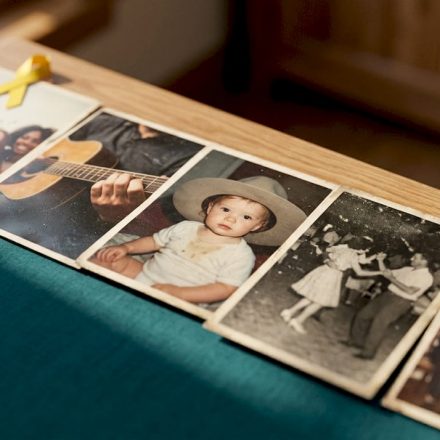 Vintage printed stills arranged on wooden table