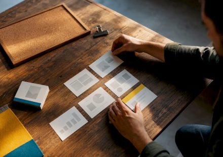 Hands arranging a presentation storyboard template