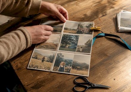 Hands arranging vintage photos into collage