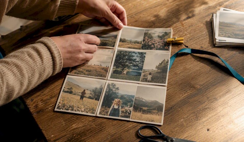Hands arranging vintage photos into collage